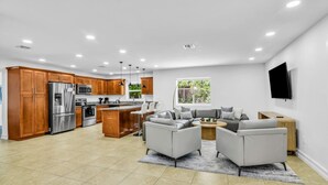 A modern kitchen with wooden cabinets, stainless steel appliances, and a central island.