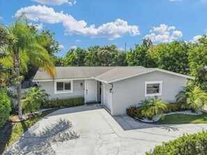 A single-story house with a front entrance, a garage, and a driveway.