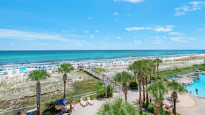 A beach resort with a pool, palm trees, and a view of the ocean. - 🌊Gulf Views~FREE Beach Svc~Kayak/SUP2~Pools+Splash Pad~BeachFRONT~3BR Azure 407 (Ft. Walton Beach)