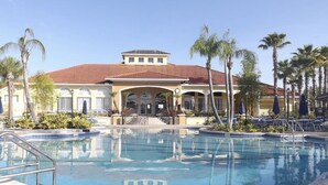 A swimming pool with a building in the background. - Amazing 3/2 Townhome With Lake View at Terra Verde!! (Kissimmee)