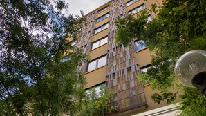 A hotel building with a modern design, featuring a prominent vertical structure and a sign indicating it is the Dunin Hotel in Athens. - Dunlin Hotel (Athens)