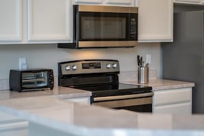 Enjoy cooking in this well-equipped kitchen with a microwave, oven, and toaster.