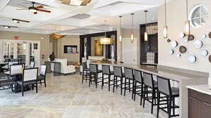 A modern hotel lobby with a bar area, seating, and a reception desk. - Solterra Resort!! Spacious House With Game Room, Private Pool and Movie Room!! (Davenport)