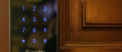 A door with a digital keypad lock labeled 'openkey'.