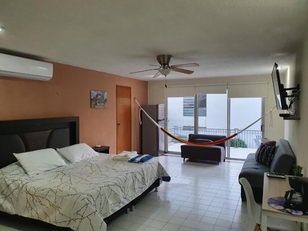 Deluxe Quadruple Room | Laptop workspace, blackout drapes, iron/ironing board, free WiFi