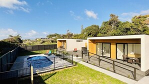 A modern residential property with a swimming pool, two separate living areas, and a deck. - Ohope Villas (Ohope)