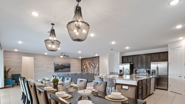 A modern kitchen with dark cabinets, stainless steel appliances, and a large island. - Arcades, Pool Table, Craps Table, Huge Galactic Bedroom: Magic Moments (Kissimmee)