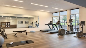 A gym with treadmills, elliptical machines, a bench, and a yoga mat. - Staybridge Suites Lexington S Medical Ctr Area (Lexington)