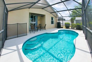 A swimming pool with a covered patio area.