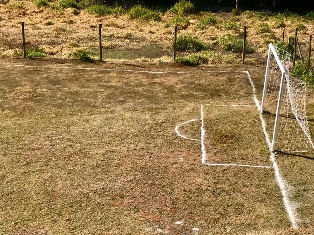 A soccer field with goalposts and a goal net.