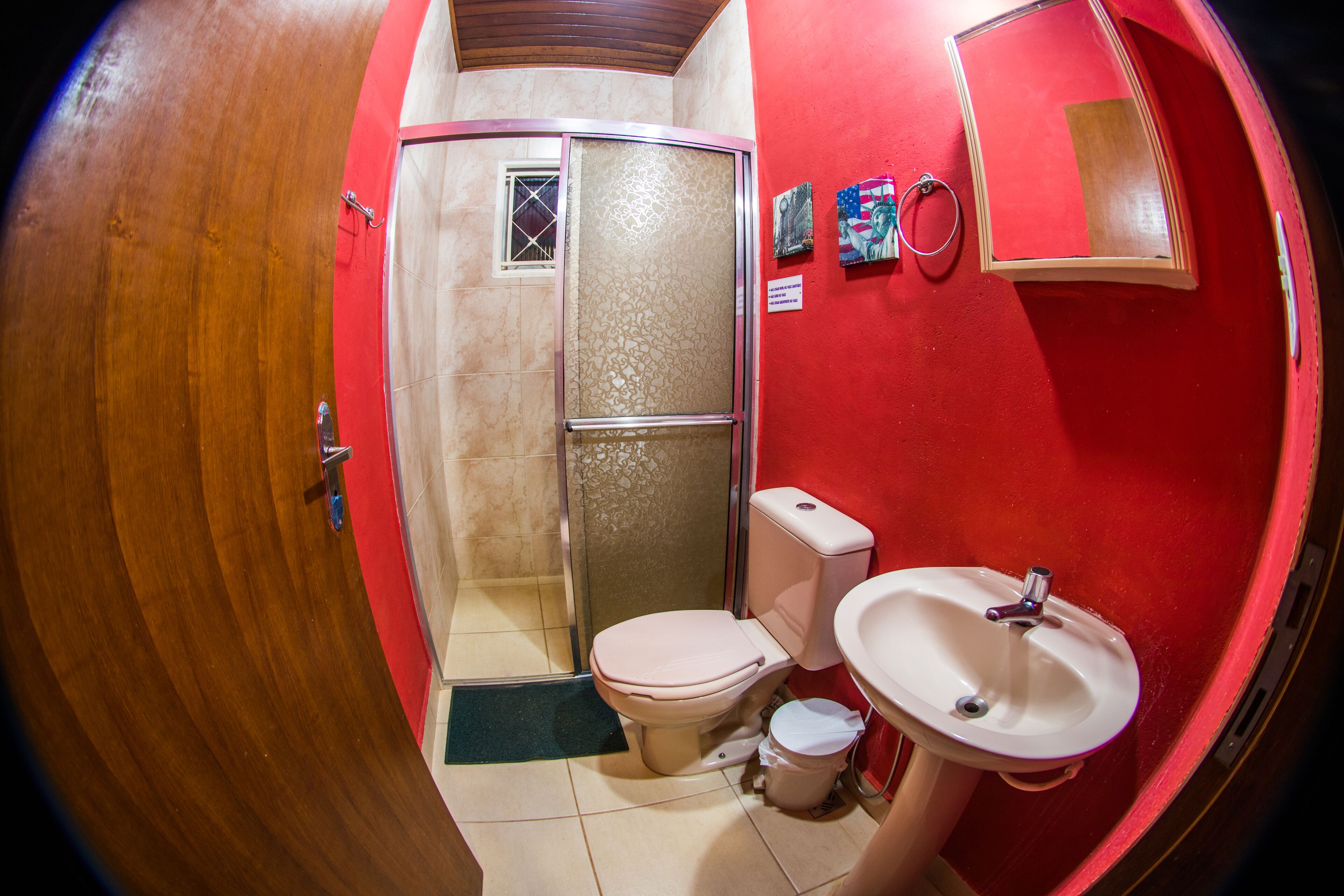A bathroom with a toilet, sink, and shower.