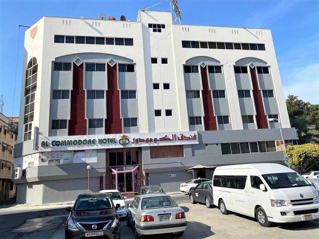 A hotel with a modern facade, multiple windows, and a visible entrance.
