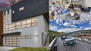 Een modern huis met een ruime garage, een woonkamer met open haard en een terras met uitzicht op een prachtig landschap.