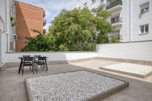 Relax on this tranquil rooftop with a seating area and lush views.
