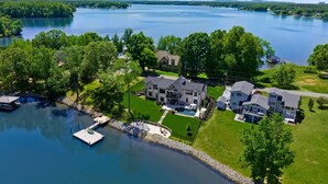 A large house with a swimming pool, dock, and lake views. - Hogan Crest w/Heated Pool & Optional Boat Rental (Mooresville)