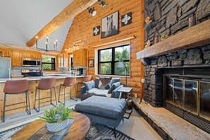 A log cabin interior with a kitchen, dining area, and fireplace. - Newly Updated Log Home on 5 acres - The Great Escape (Sister Bay)