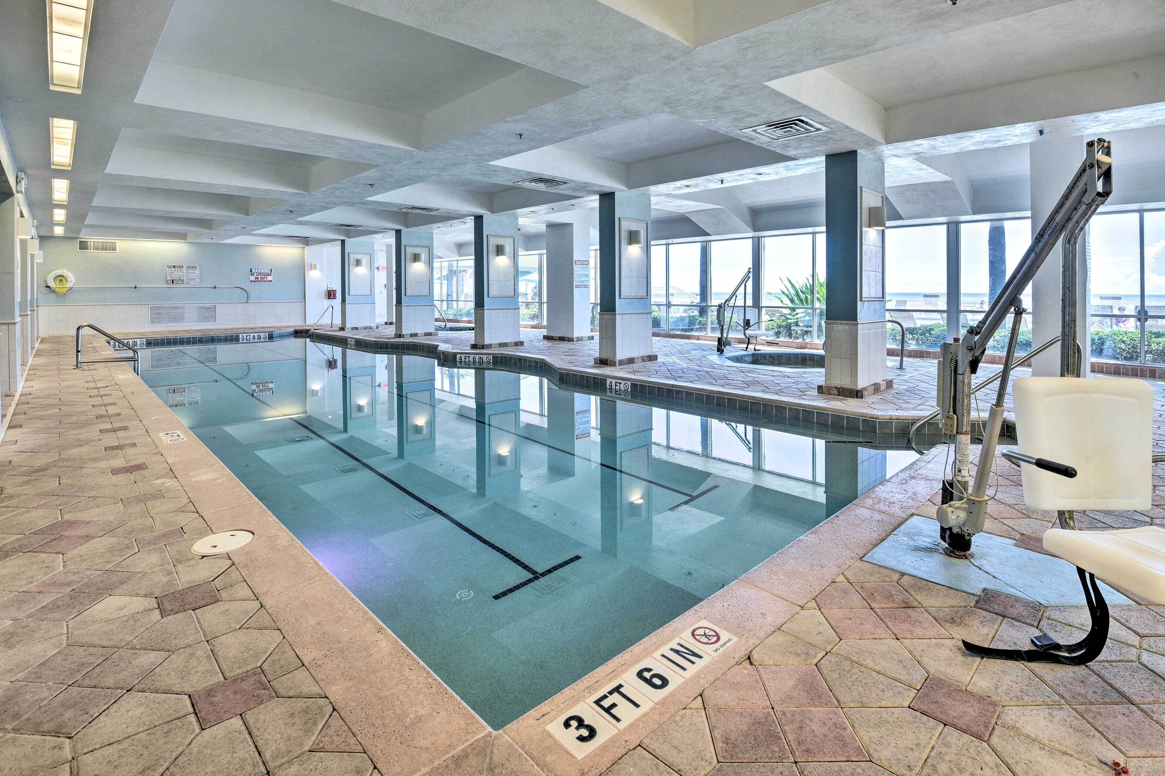 An indoor swimming pool with clear lane markings, a lifeguard chair, and a tiled floor with a 3 ft 6 in depth marker.
