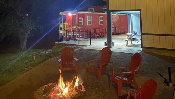 A building with a fire pit and outdoor seating.