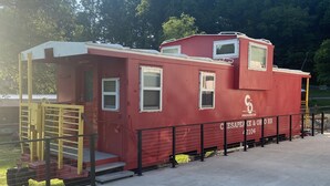 A red building with multiple windows and a small staircase, labeled "C&O 42104".