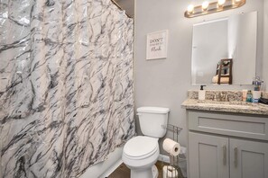 Combined shower/tub, hair dryer, towels, toilet paper