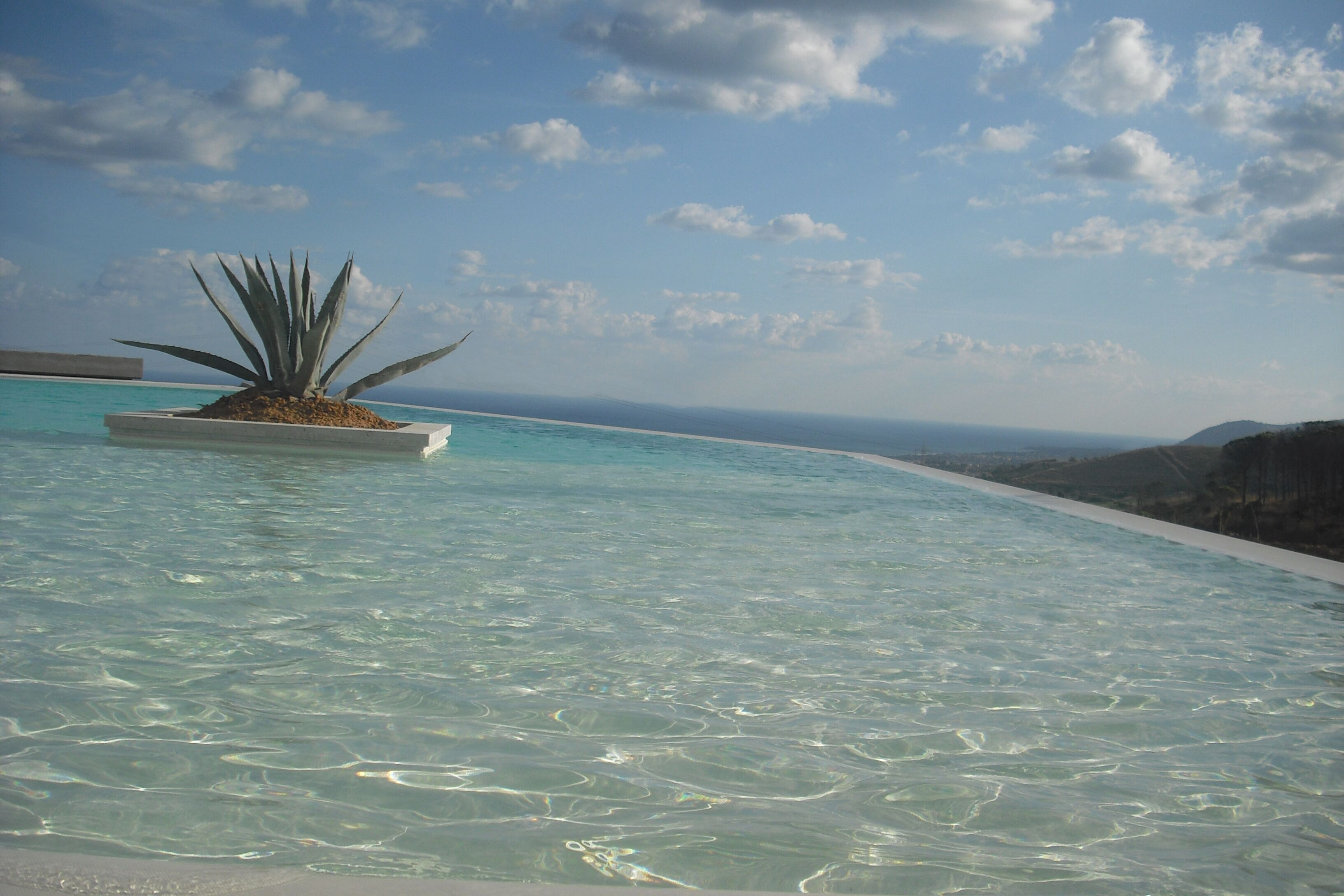 Una piscina al aire libre de temporada, sillones reclinables de piscina