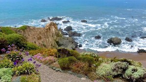 A coastal landscape with rocky terrain and vegetation.