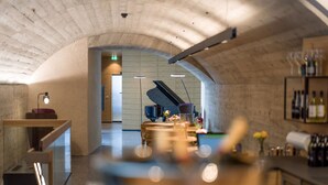 A spacious, modern interior with a piano, a bar area, and a seating arrangement. - Platzhirsch Kufstein (Kufstein)