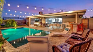 A modern outdoor pool area with a bar and seating. - Gorgeous Scottsdale Home w/ Heated Pool (Scottsdale)