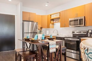 Enjoy cooking and dining in this fully equipped kitchen with a refrigerator, oven, microwave, and sink.