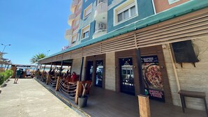 Un immeuble à plusieurs étages avec un restaurant situé au rez-de-chaussée.