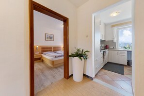 Une chambre à coucher avec un lit, une table de chevet et une plante en pot.