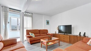 A living room with a sofa, coffee table, TV, and wooden cabinet. - Holiday Home Casa Carmencita with Sea Views, Pool and Wi-Fi (La Garita)