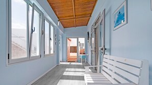 A hallway with a wooden ceiling, white benches, and a view of the outside. - Holiday Home Casa Carmencita with Sea Views, Pool and Wi-Fi (La Garita)