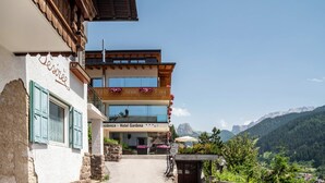 A hotel with a balcony, a sign reading 'Hotel Gardena,' and a mountain view in the background. - Apartment 'Hotel Residence Gardena Sella' with Mountain View, Garden & Wi-Fi (St. Christina)