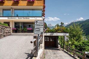 A hotel entrance with a sign indicating a check-in area and a garage.