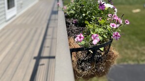 A wooden deck with flower planters.