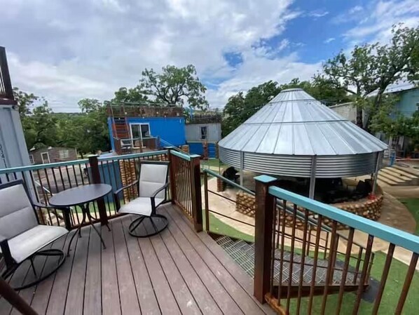A wooden deck with outdoor seating and a gazebo.
