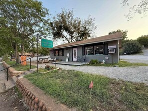 A small building with a sign for 'Chadwick's Bakery' and a picnic table outside. - KB Book Fort Sill Tiny House, Slps 4 1BR/1BA. (Medicine Park)