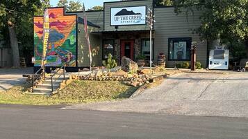 A building with a sign reading 'UP THE CREEK SPIRITS' and a colorful mural on the left.