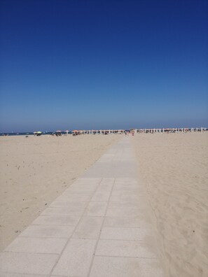 A wide, sandy beach with a clear sky. - Right on the beach (Lido di Spina)