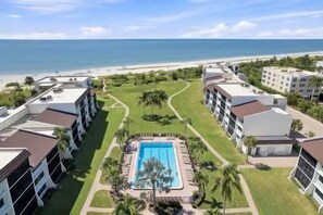 A hotel with a pool, a beach view, and a golf course. - Loggerhead 351 | Sunny Sanibel | Gorgeous Walkout Unit | Gulf Views (Sanibel)