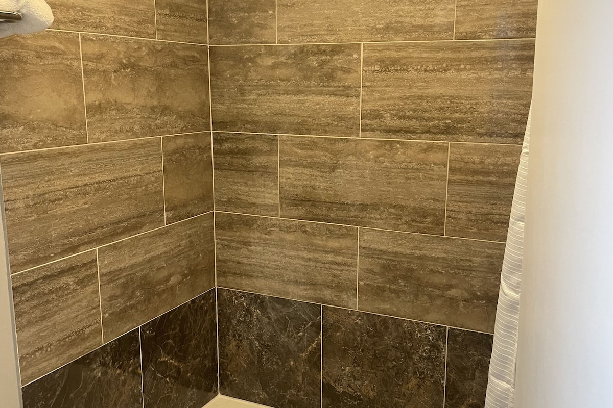 deluxe double room, 1 king bed | bathroom | rainfall showerhead, free toiletries, hair dryer, towels