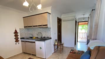 Basic Apartment, 1 Double Bed with Sofa bed, Garden View | Private kitchen | Mini-fridge, stovetop, cookware/dishes/utensils, dining tables