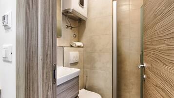 Shower, towels, soap, toilet paper