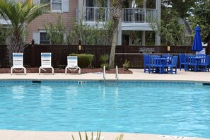 Relax by the 6-foot pool surrounded by lush greenery and comfortable lounge chairs.