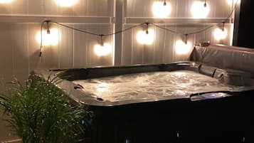 Relax in the hot tub surrounded by a serene ambiance.