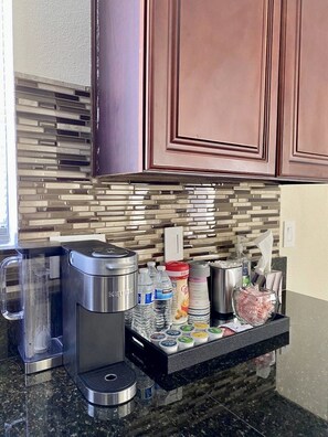Enjoy a fully equipped kitchen with a water dispenser and coffee maker.