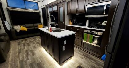 Luxury RV with full kitchen sleeps family of 6 inside fenced property