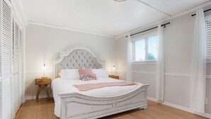 A bedroom with a white bed, wooden floor, and a window with white curtains. - Newly Renovated-Spacious-20min to Den& Boulder-HotTub/Game Room/Basketball Court (Westminster)