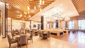 A spacious lobby with modern furniture, a reception desk, and a chandelier. - Taibai Mountain Wanguo Hotel (Mei County)